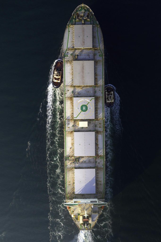 Aerial Photography of a Cargo Ship and Tag Boats